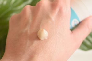 Green People day solution cream on the back of my hand