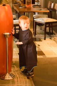 Jonah playing and wearing his Messy Little Thing bib