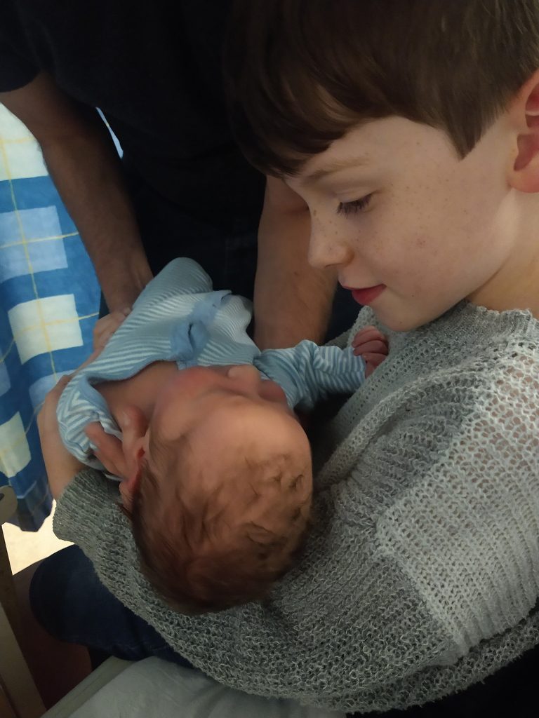 Jonah holds Eleanor for the first time