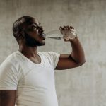 How can men maintain body water balance throughout the year?