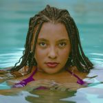 stunning portrait of woman with braided hair in pool